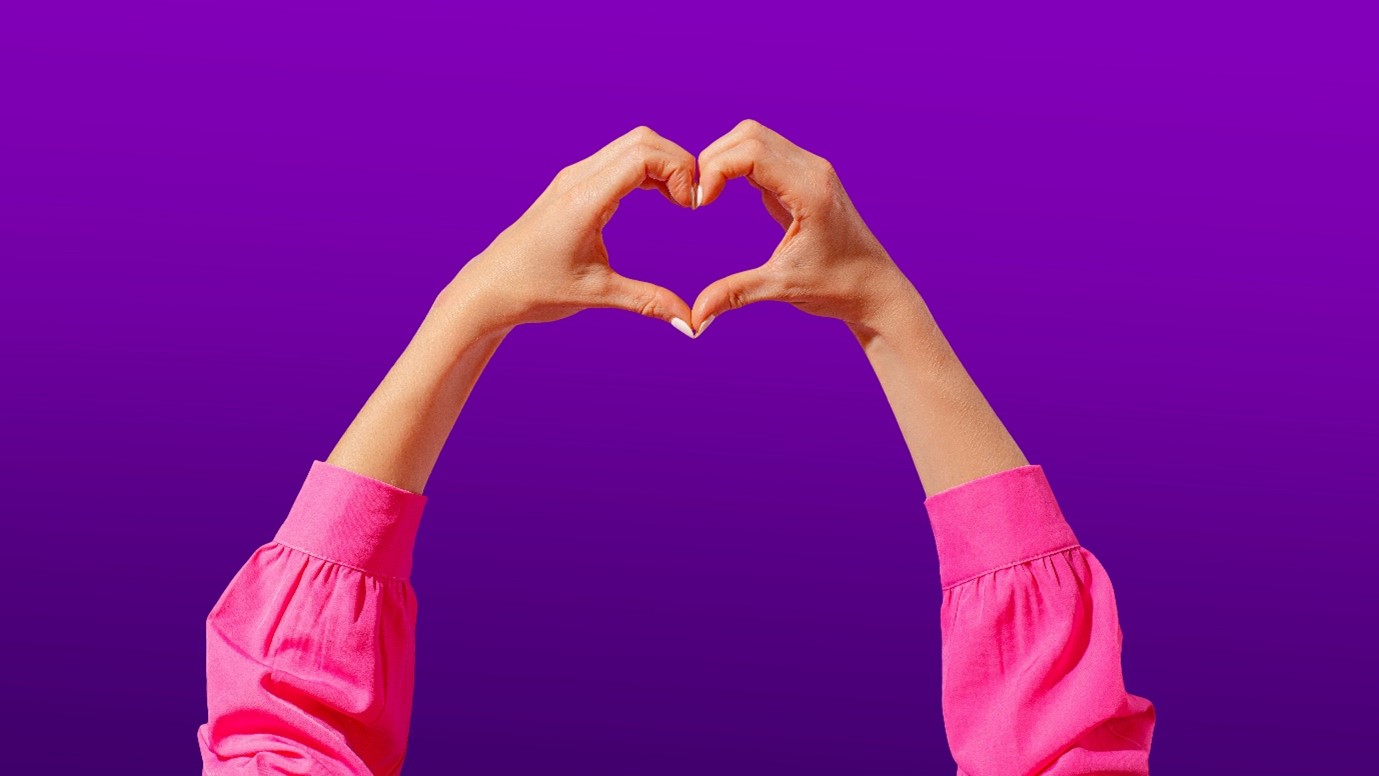 A woman making a love heart symbol with her hands, for “Stand in Your Space: A Unique Group Coaching Journey for Women”